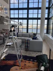 A ladder in the middle of a living room.