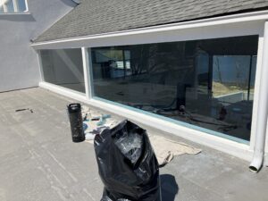 Black garbage bag on a rooftop deck.