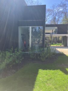 Black modern house with glass doors.
